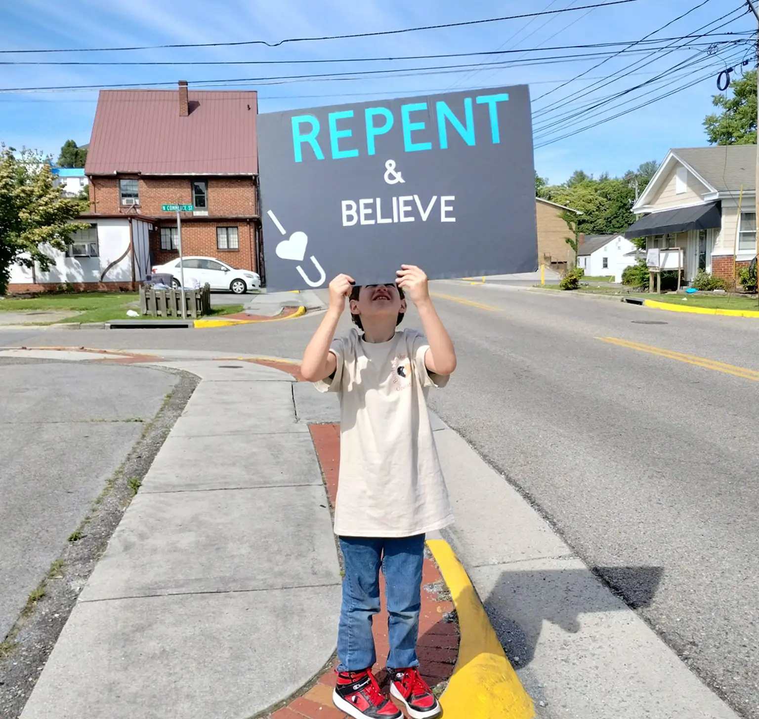 The boy with a bunner telling about faith